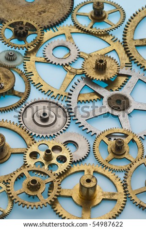 Close up of old brass and steel clock gears with limited depth of field