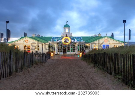 NOORDWIJK, NETHERLANDS - OCTOBER 14: Dramatic sunset sky over the Beach Club of Hotel von Oranje in Noordwijk, Netherlands as seen from across the dunes leading to the beach on October 14, 2014