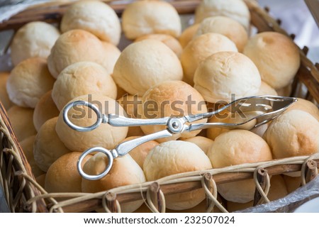 golden soft bun in wood basket with metal holder