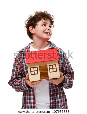 Boy holding model of house isolated on white