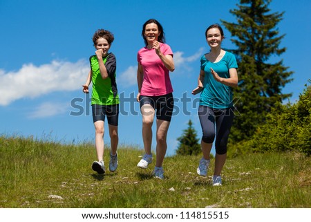 Active family - mother and kids running outdoor
