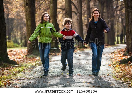 Active family - mother and kids walking, running outdoor