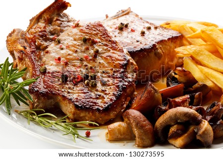 Fried pork chop, chips and vegetable salad