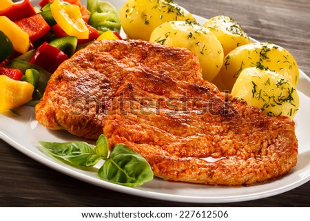 Pork chops, boiled potatoes and vegetables