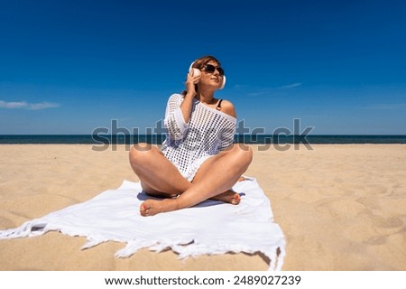 Similar – Image, Stock Photo Woman resting on sandy beach on cloudy day