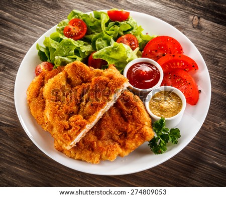 Fried pork chops and vegetable salad