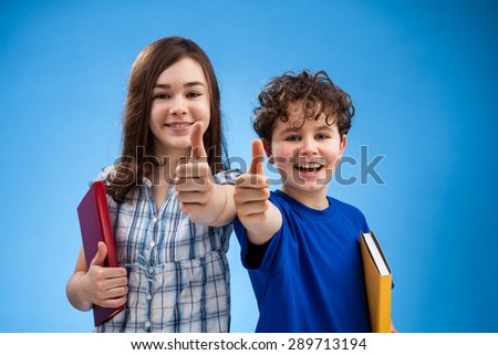 Students showing OK sign on blue background