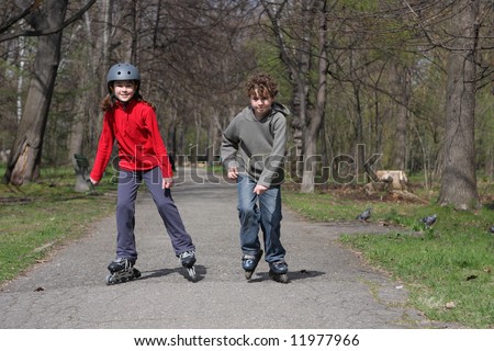 Young girl and boy on roller blades