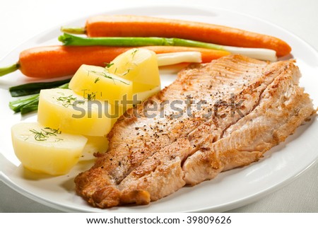 Fish dish - roasted trout fillet with potatoes and vegetables