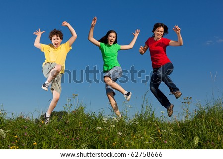 Happy family jumping, running outdoor