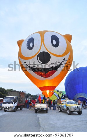 PUTRAJAYA, MALAYSIA-MAR 15:Unique Cat face balloon in flight at the 4th Putrajaya International Hot Air Balloon Fiesta Mar 15, 2012 in Putrajaya. 6 special shape balloons participate in this year.