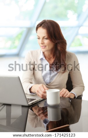 Portrait of a beautiful business woman sitting in the office