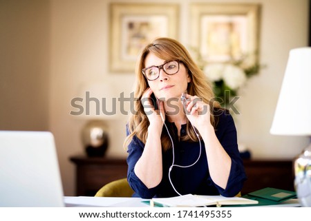 Similar – Image, Stock Photo Attractive woman with headphones showing the tattoos on her hands on a pink background
