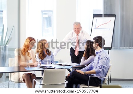 Executive senior businessman presenting his idea at meeting.  Teamwork at office.