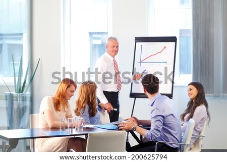 Senior businessman presenting ideas to his colleagues.