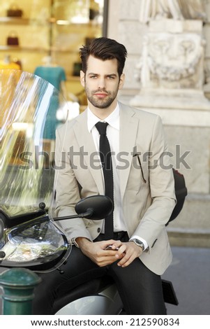 Modern businessman sitting on scooter in the city. Business people.