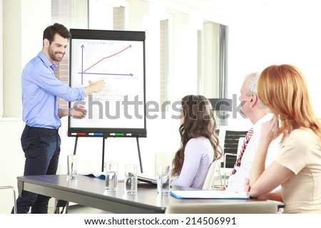 Portrait of executive businessman presenting his idea to his colleagues at meeting. Teamwork.