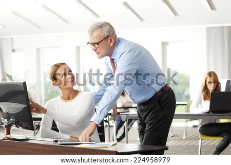 Executive financial advisor working together with business woman at office.