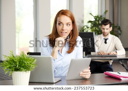 Close-up portrait of executive business woman holding digital tablet while working on project at office. Business meeting.