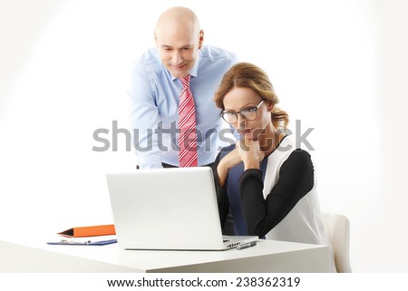 Portrait of efficiency sales team working on laptop while sitting against white background.
