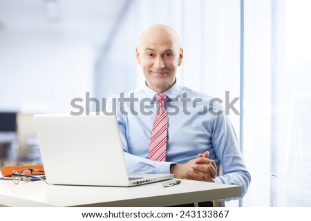 Portrait of efficiency sales man sitting in front of laptop at office.  Business people.