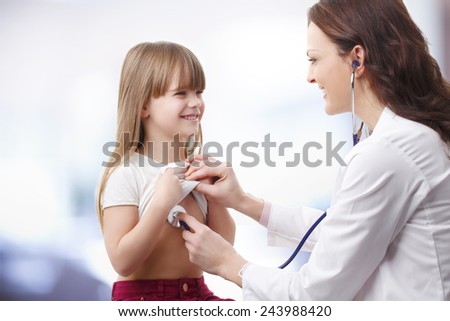 Female doctor listening heart break of preschool child at private clinic.