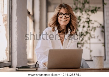 Similar – Image, Stock Photo Smiling woman sitting on bench in park with closed eyes on sunny day