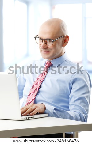 Portrait of efficiency financial advisor analyzing data at computer while sitting at office.