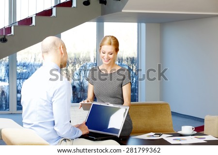 Business consultation. Businesswoman and businessman sitting at office and using computer and digital tablet.