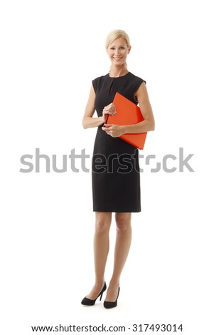 Full length portrait of executive lawyer woman holding in her hands official documents while standing against white background.