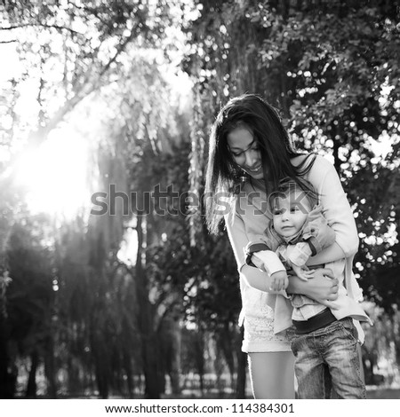 happy mother playing with her son in the park,black and white
