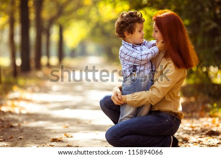 happy mother playing with her son in the park