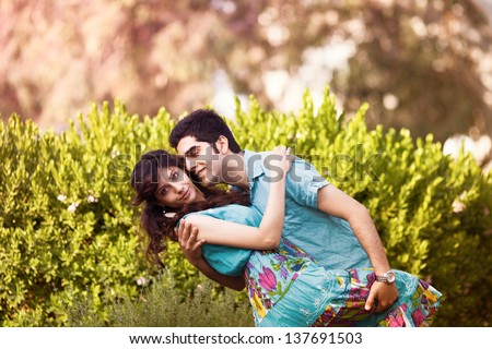 young couple in love cuddling in the park, circling in the dance