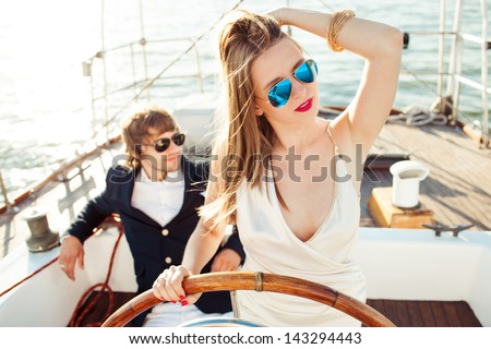 fashion beautiful couple in romantic trip on yacht