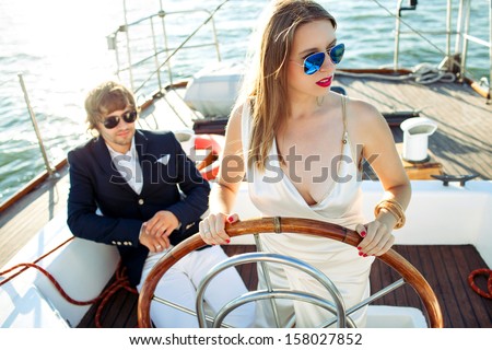 fashion beautiful couple in romantic trip on yacht