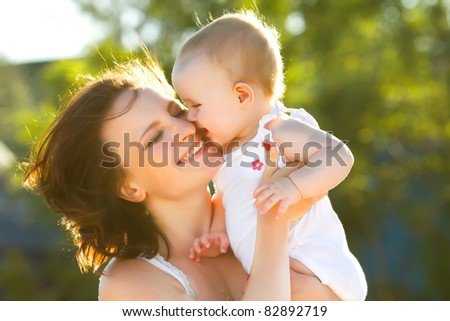 happy mom and daughter smiling at nature