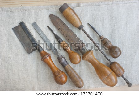 Set of old tools on linen cloth.
