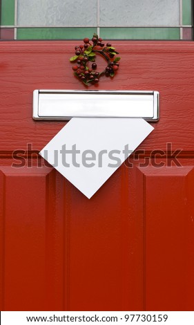 Red front door with mail (post) box and a white letter (envelope). Christmas mail concept. Space for your text.
