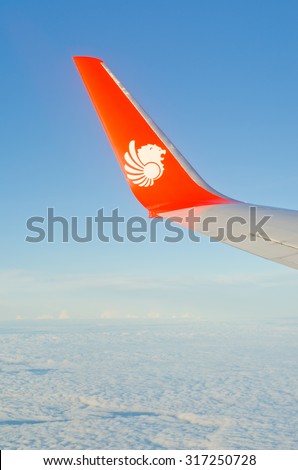 Chiangmai, Thailand - AUGUST 24: Thai Lion air plane\'s wing with logo on the window, the plane flying over Chiangmai to Bangkok on August 24 2015