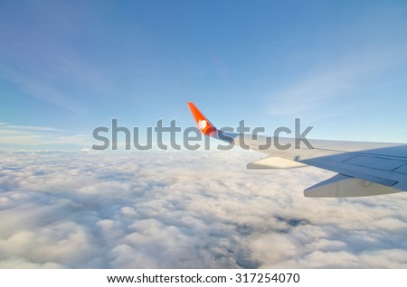 CHIANGMAI, THAILAND - AUGUST 24: Thai Lion Air plane\'s wing with logo on the window, the plane flying over Chiangmai to Bangkok Thailand on August 24 2015.