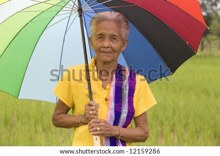 old Asian woman with colorful umbrella