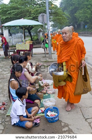 2008-08-16: Luang Prabang, Laos: Buddhistic monks move through the town in the dawn in Laos, Luang Prabang