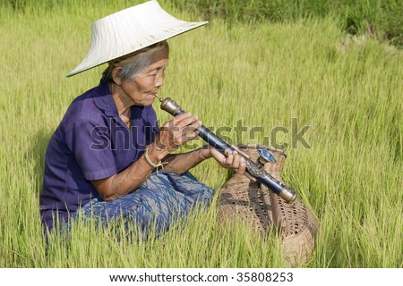 old Asian woman with opium pipe
