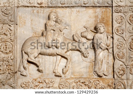 VERONA - JANUARY 27: Relief of Flight to Egypt from facade of romanesque Basilica San Zeno. Reliefs is work of the sculptor Nicholaus and his workshop on January 27, 2013 in Verona, Italy.