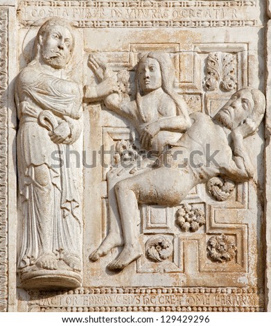 VERONA - JANUARY 27: Relief of creation of woman facade of romanesque Basilica San Zeno. Reliefs is work of the sculptor Nicholaus and his workshop on January 27, 2013 in Verona, Italy.