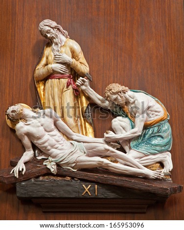 VERONA - JANUARY 28: Jesus is nailed to the cross. One part of ceramic coss way from st. Nicholas church (Chiesa di San Nicolo) on January 28, 2013 in Verona, Italy.