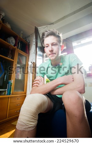 Teenager with a bandaged knee.