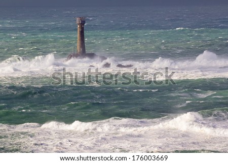 Huge waves and Longships Lighthouse photographed from Lands End Cornwall England UK