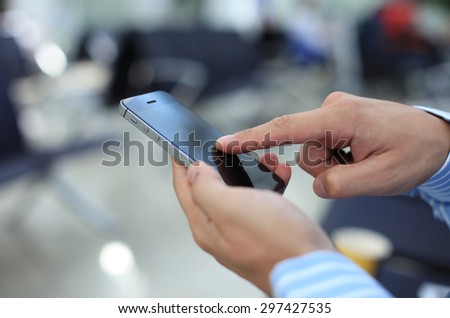 Close up of a business man using mobile smart phone