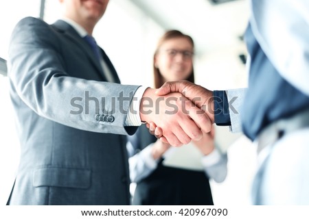 Photo of Business people shaking hands, finishing up a meeting